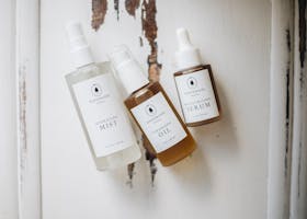 Flat lay of organic skincare products on rustic background, ideal for beauty and wellness use.
